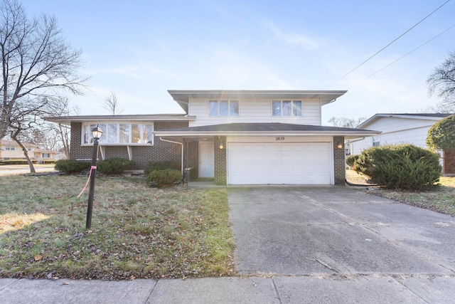 view of front of house with a garage and a front lawn