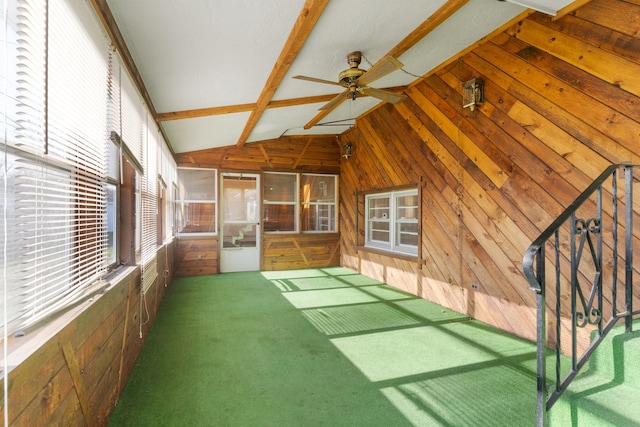 unfurnished sunroom with vaulted ceiling with beams and ceiling fan