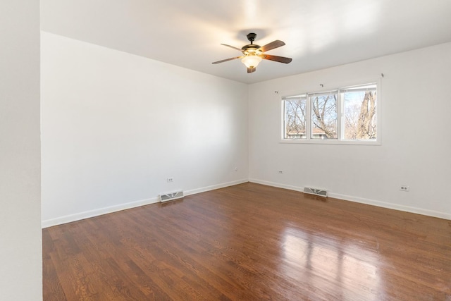 unfurnished room with ceiling fan and dark wood-type flooring