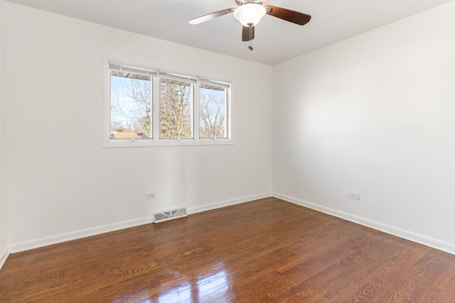 unfurnished room with ceiling fan and dark hardwood / wood-style flooring