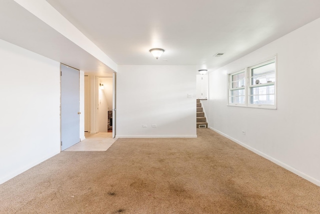 unfurnished room featuring light carpet