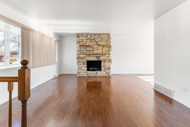 unfurnished living room featuring dark hardwood / wood-style flooring and a fireplace