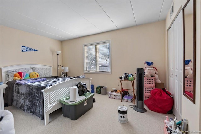 carpeted bedroom with a closet