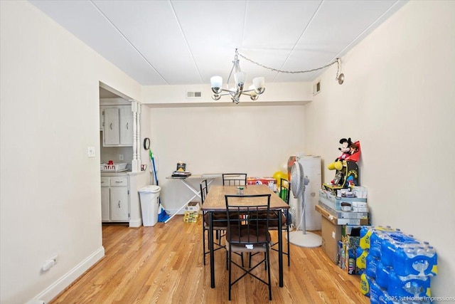 dining area with a notable chandelier and wood-type flooring