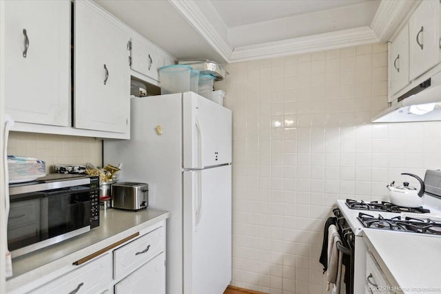 kitchen featuring white cabinets, decorative backsplash, white appliances, and ornamental molding