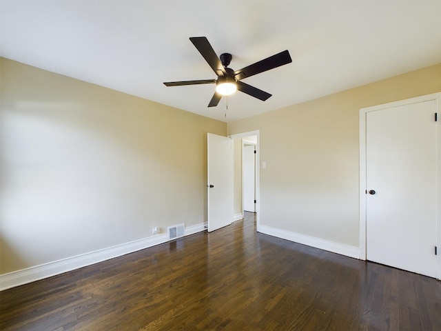 unfurnished bedroom with ceiling fan and dark wood-type flooring