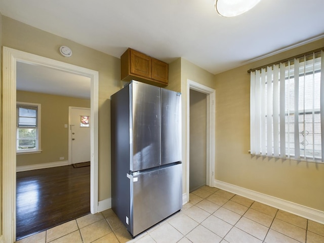 kitchen with stainless steel fridge and light tile patterned flooring