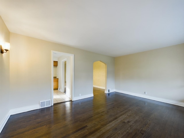 spare room with dark wood-type flooring