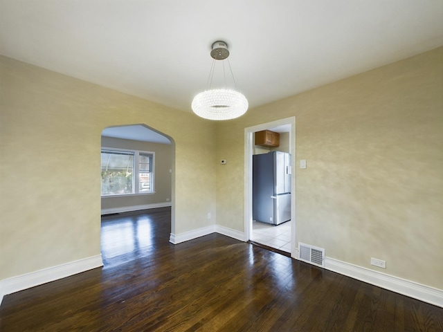 unfurnished room with hardwood / wood-style flooring