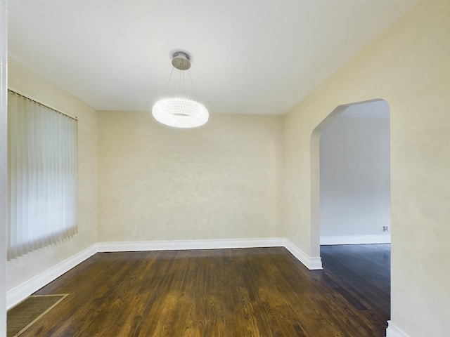 unfurnished dining area with dark wood-type flooring