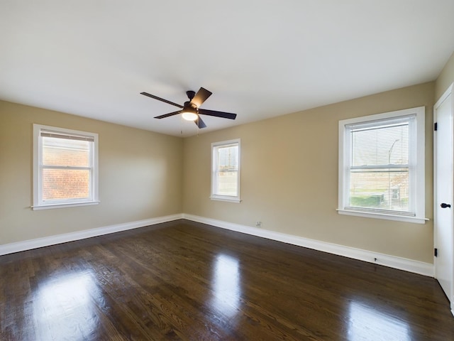 empty room featuring ceiling fan and dark hardwood / wood-style flooring