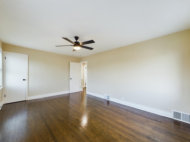 spare room with ceiling fan and dark wood-type flooring