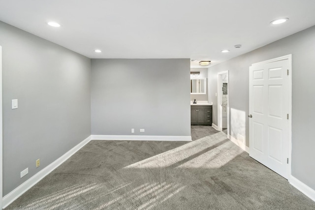 carpeted spare room with sink