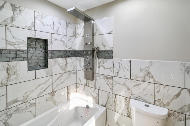 bathroom with toilet, tiled shower / bath, and tile walls