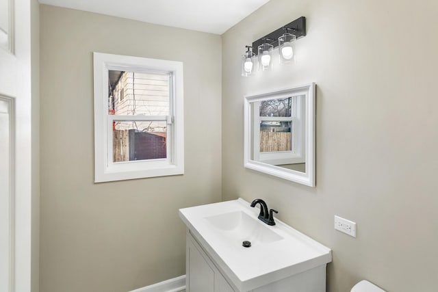 bathroom featuring vanity and toilet