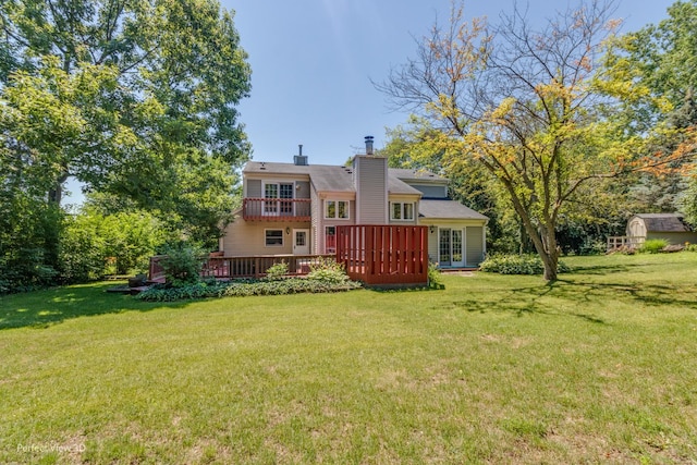 back of property with a lawn and a deck