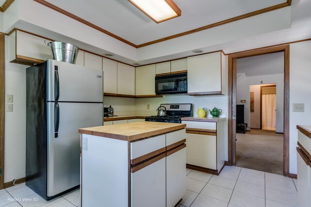 kitchen featuring appliances with stainless steel finishes, white cabinetry, and a kitchen island