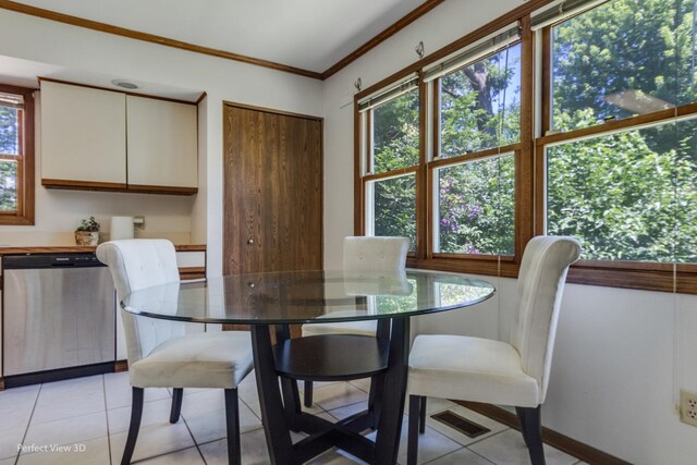 dining space with crown molding and light tile patterned flooring