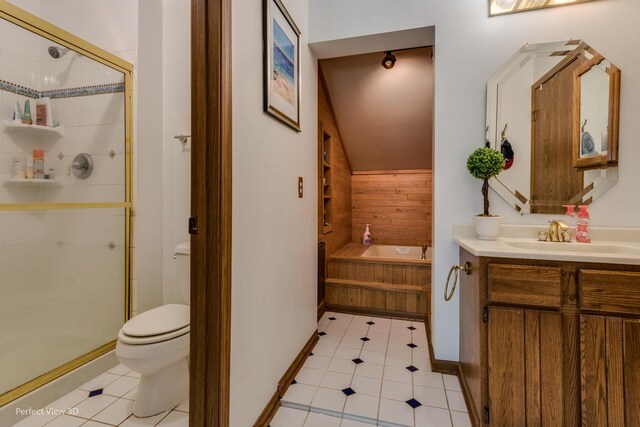 full bathroom featuring tile patterned floors, vanity, shower with separate bathtub, and toilet