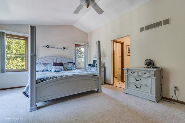 carpeted bedroom featuring ensuite bathroom, vaulted ceiling, and ceiling fan