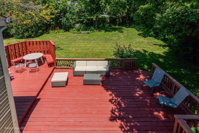 wooden deck featuring outdoor lounge area and a lawn