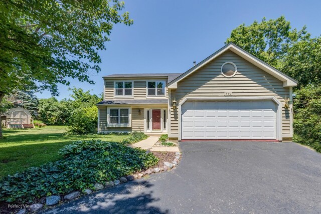 view of front of home featuring a garage and a front yard