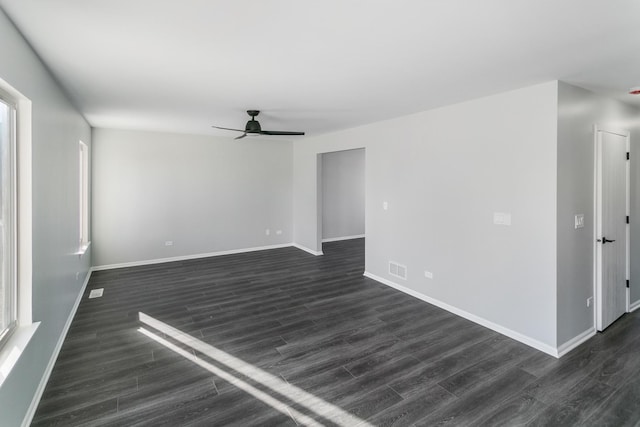 unfurnished room featuring ceiling fan and dark wood-type flooring