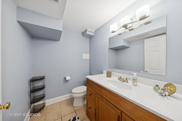 bathroom with tile patterned flooring, vanity, and toilet