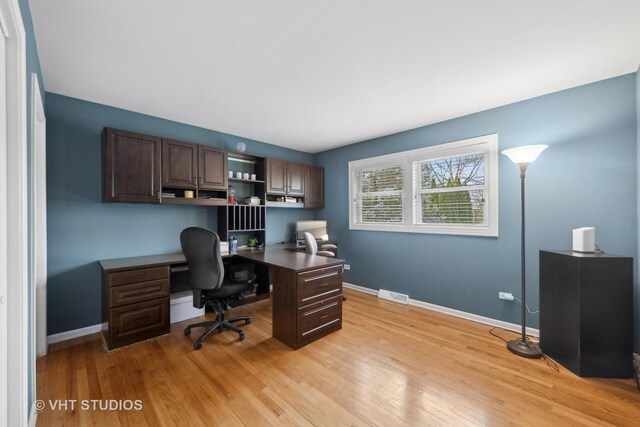 laundry room featuring washing machine and dryer and light hardwood / wood-style flooring