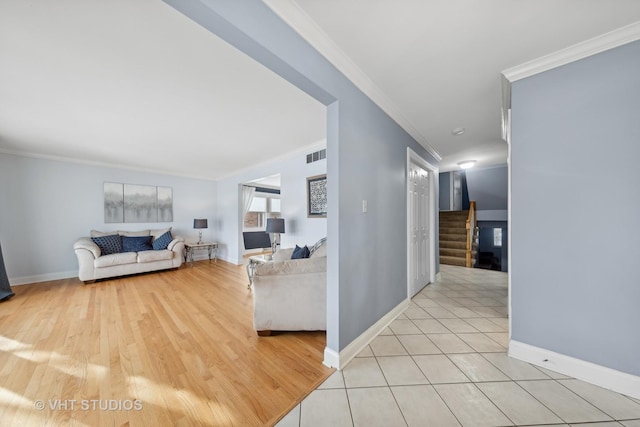 living room featuring ornamental molding and light tile patterned floors