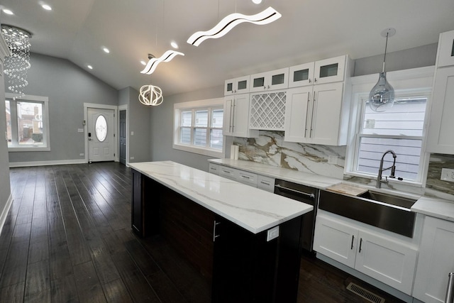 kitchen with a notable chandelier, white cabinetry, decorative light fixtures, and a kitchen island