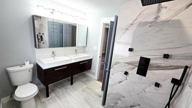 bathroom with toilet, wood-type flooring, and vanity