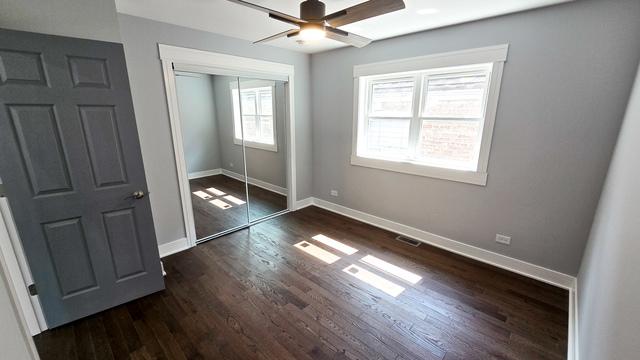 unfurnished bedroom featuring ceiling fan, a closet, and dark hardwood / wood-style floors