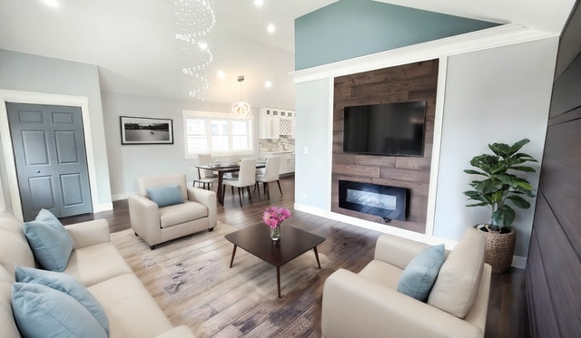 living room featuring an inviting chandelier and wood-type flooring