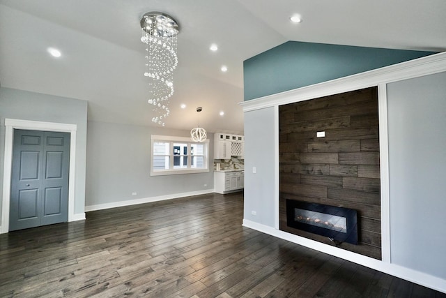 unfurnished living room with lofted ceiling, a chandelier, and dark wood-type flooring