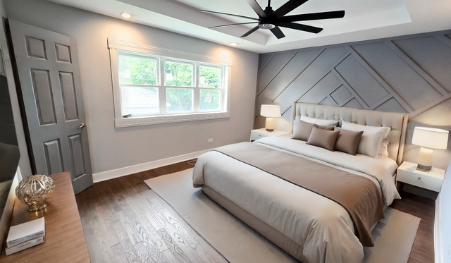 bedroom with ceiling fan and dark hardwood / wood-style floors