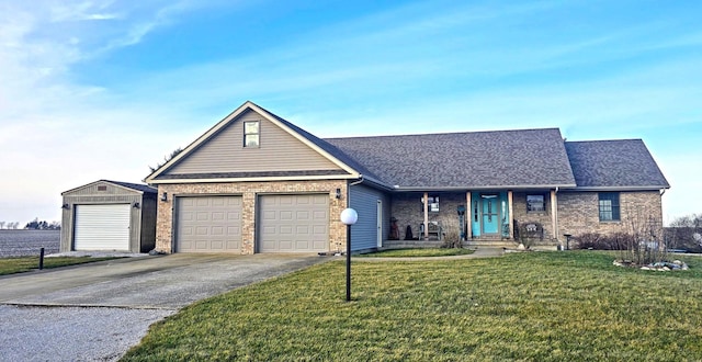 ranch-style house featuring a front yard and a garage