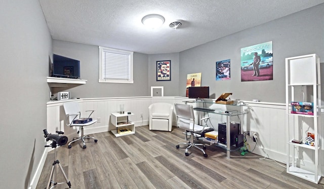 office area featuring wood-type flooring and a textured ceiling