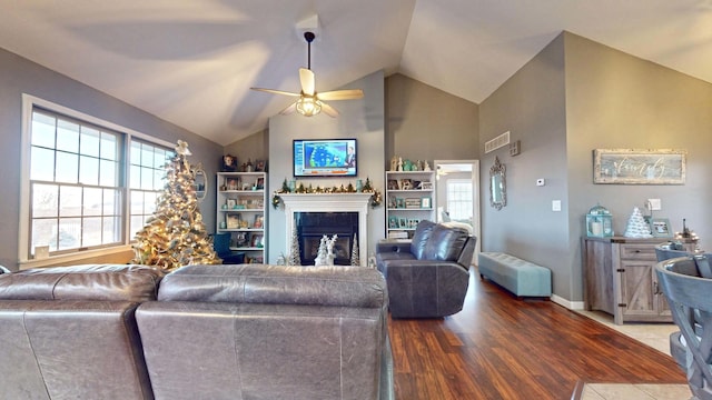 living room with hardwood / wood-style floors, vaulted ceiling, and ceiling fan