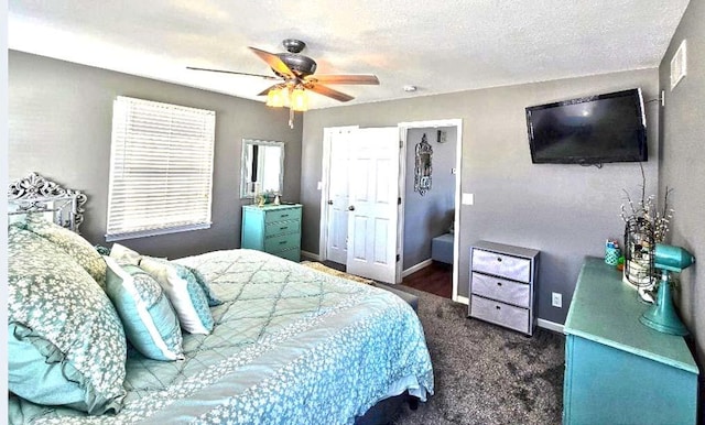 bedroom with dark colored carpet, a textured ceiling, and ceiling fan