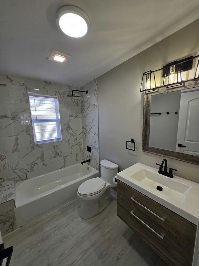 full bathroom with vanity, tiled shower / bath combo, and toilet