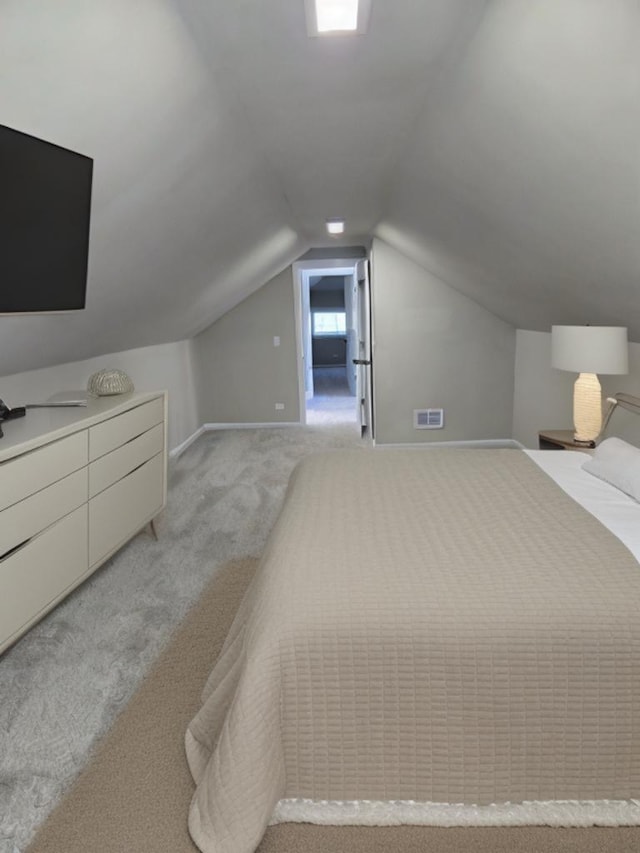 carpeted bedroom with lofted ceiling