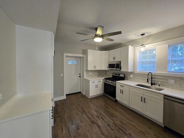 kitchen featuring white cabinetry, sink, ceiling fan, decorative backsplash, and appliances with stainless steel finishes