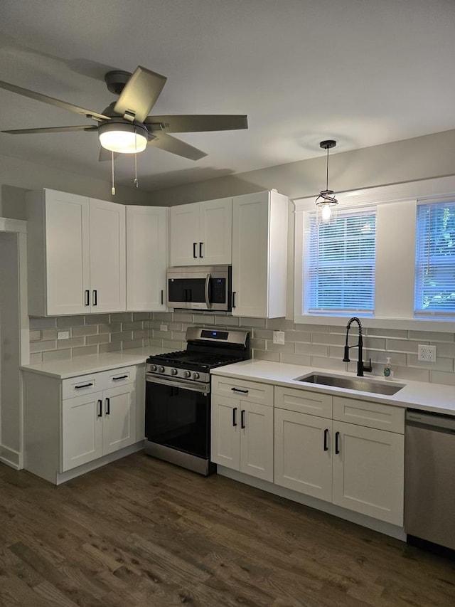 kitchen with sink, white cabinetry, stainless steel appliances, and tasteful backsplash