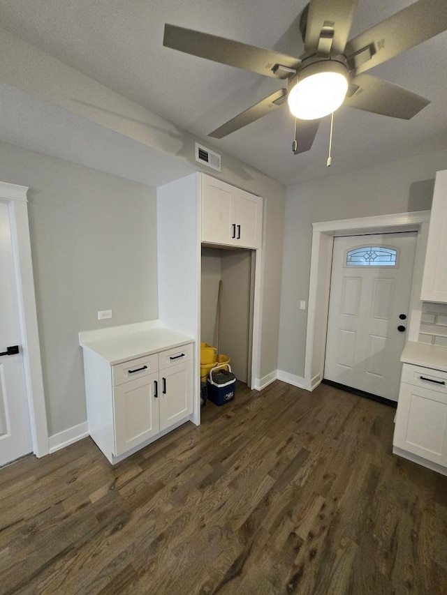 kitchen featuring white cabinets, dark hardwood / wood-style flooring, tasteful backsplash, and ceiling fan