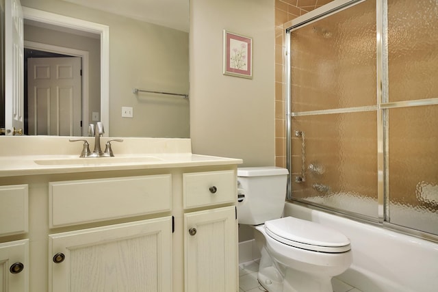 full bathroom with toilet, vanity, tile patterned floors, and bath / shower combo with glass door