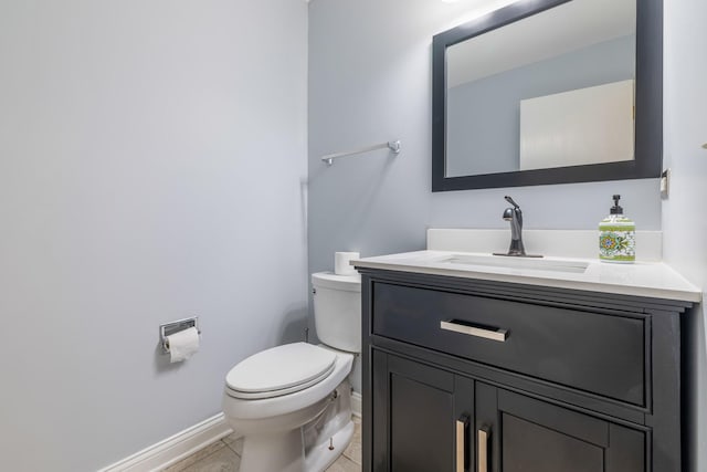 bathroom with tile patterned flooring, vanity, and toilet