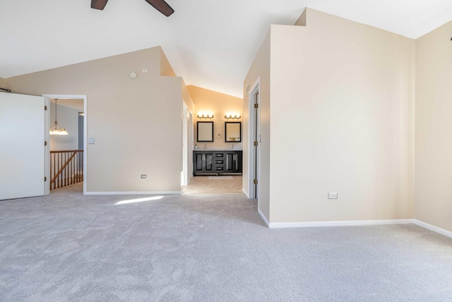 unfurnished room with ceiling fan, carpet floors, and vaulted ceiling