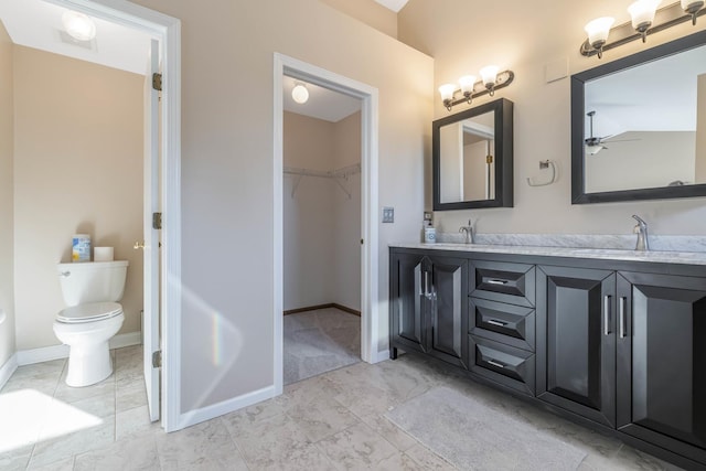 bathroom with ceiling fan, vanity, and toilet