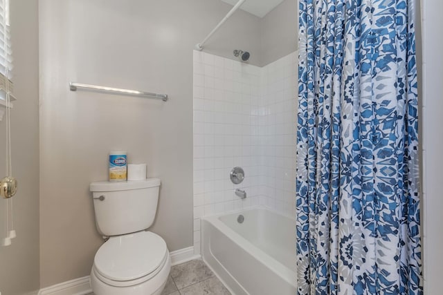 bathroom with tile patterned floors, toilet, and shower / bath combo with shower curtain